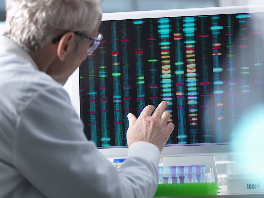 DNA Research, Scientist comparing DNA results on a computer screen in the laboratory